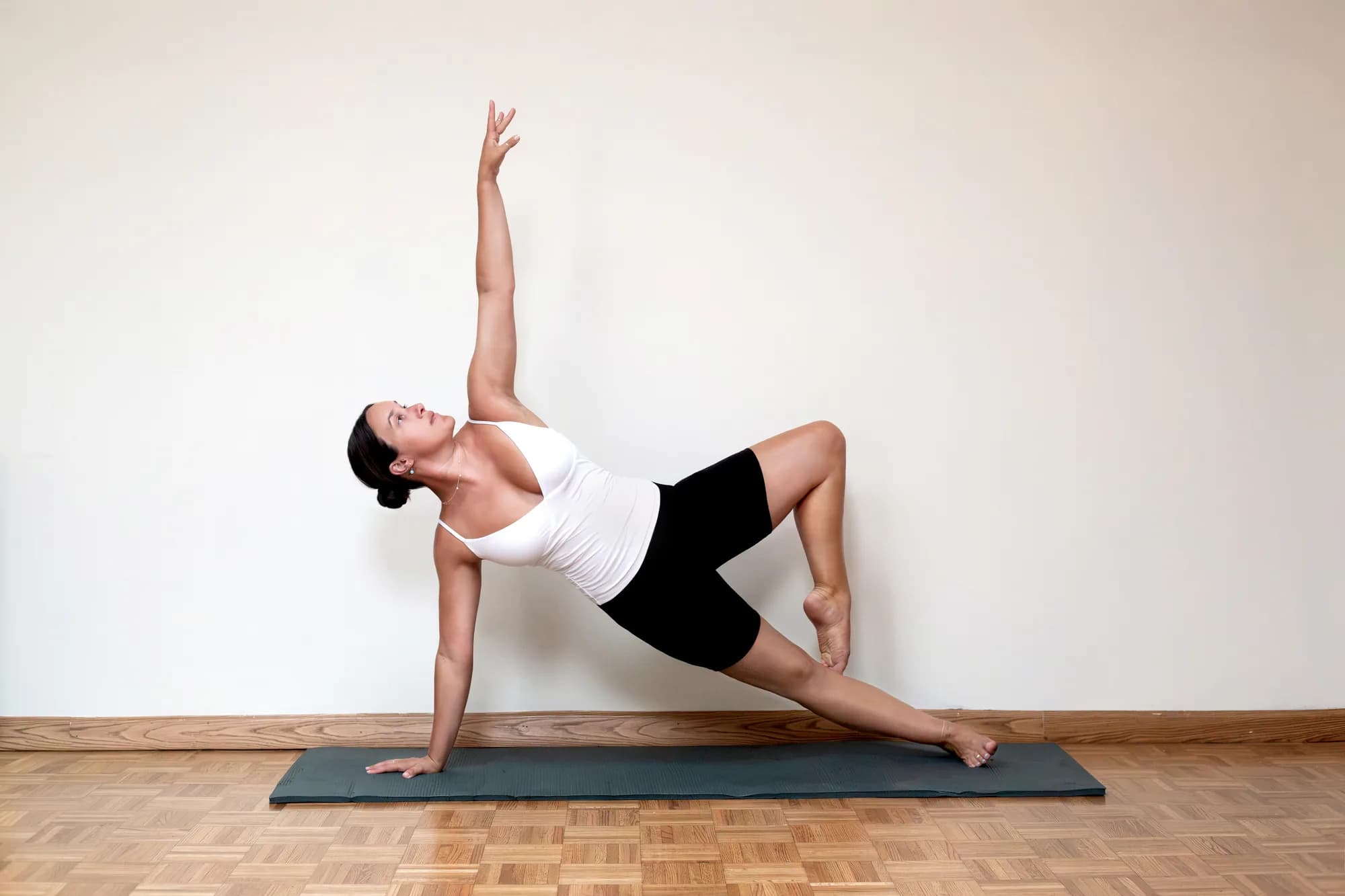 Sculpt & Stretch Pilates instructor demonstrating a side plank pose